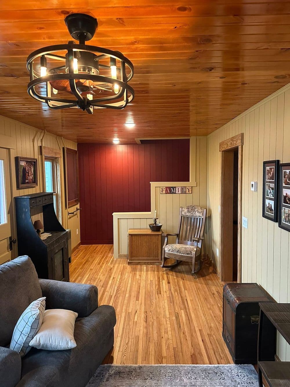 Cozy living room with wood floors, vintage decor, and a warm color palette.